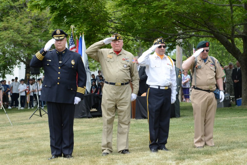 Wilmington Police Chief Michael Begonis & Wilmington veterans saluting during a veterans roll call of Wilmington service members killed or missing in action.