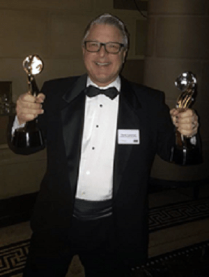 Steve Lassman, Vice President of Villa Product &amp; Agency Relations for Villas of Distinction accepts the Travvy Award